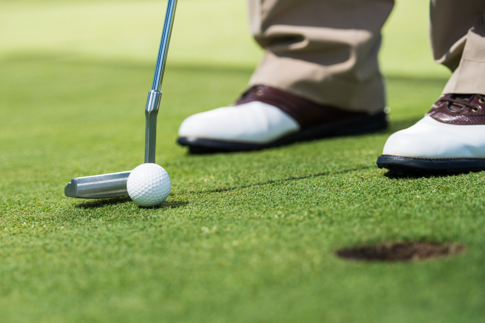 Golf player putting green.